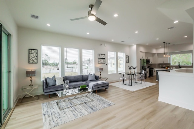 5703 Balbo St Unit B, Houston, TX 77091 - living area with light wood-style flooring, ceiling fan, recessed lighting, and baseboards