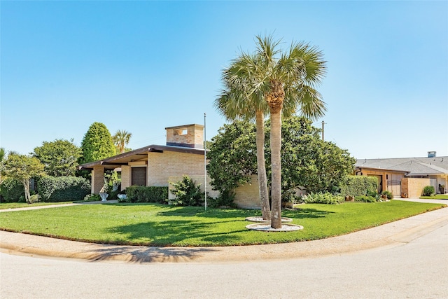 38 Adler Cir, Galveston, TX 77551 - view of front facade featuring brick siding and a front lawn
