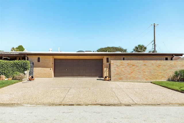 38 Adler Cir, Galveston, TX 77551 - view of front of home with an attached garage, brick siding, and driveway
