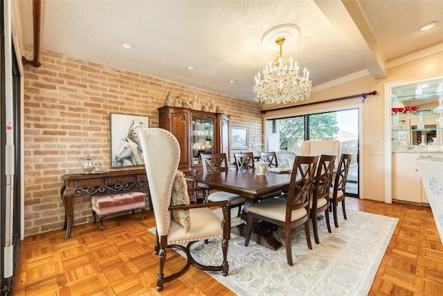 38 Adler Cir, Galveston, TX 77551 - dining area featuring a textured ceiling, a chandelier, brick wall, and beam ceiling