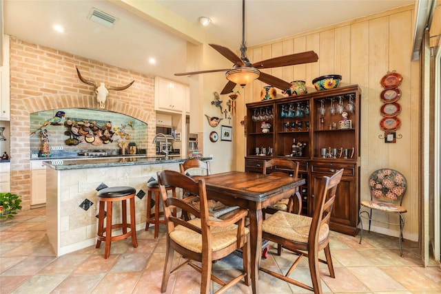38 Adler Cir, Galveston, TX 77551 - dining space featuring a ceiling fan and wood walls