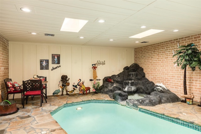 38 Adler Cir, Galveston, TX 77551 - view of swimming pool with a skylight and a hot tub