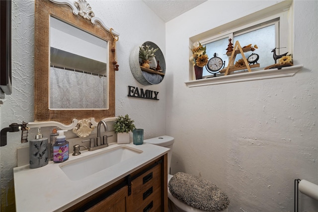 4931 Glendower Dr, Spring, TX 77373 - bathroom featuring toilet, a textured wall, and vanity
