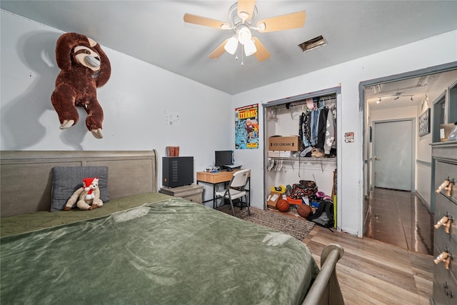 4931 Glendower Dr, Spring, TX 77373 - bedroom featuring wood finished floors, an office area, a ceiling fan, and a closet