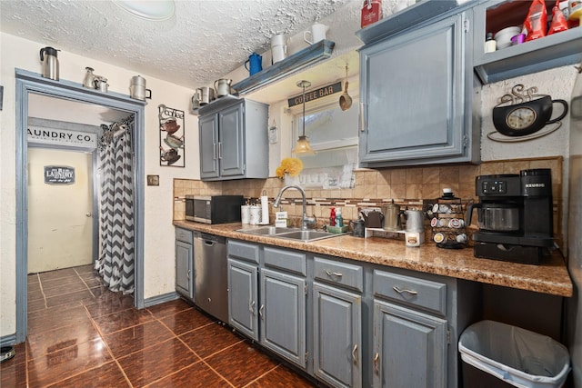 4931 Glendower Dr, Spring, TX 77373 - kitchen with a sink, stainless steel dishwasher, gray cabinets, tasteful backsplash, and a textured ceiling