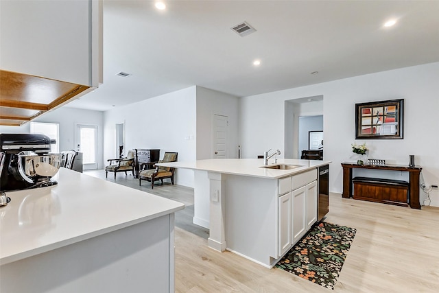 31611 Farlam Farms Trl, Fulshear, TX 77441 - kitchen with a sink, white cabinetry, light wood finished floors, a kitchen island with sink, and light countertops