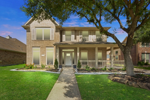 4914 Fern Cove Dr, Baytown, TX 77521 - view of front of property featuring brick siding, a front lawn, and a porch