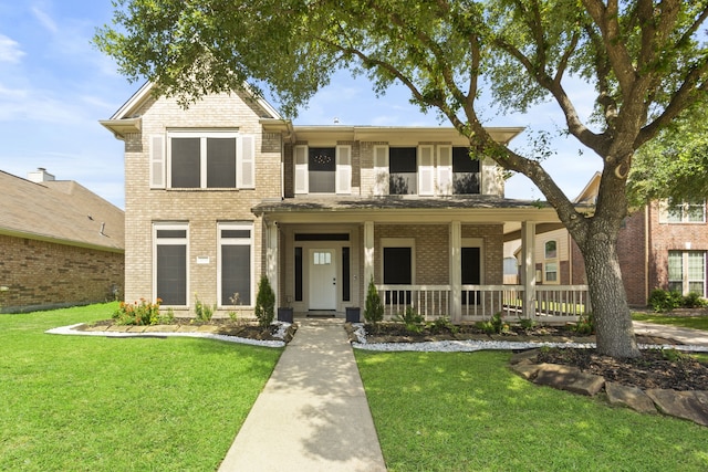 4914 Fern Cove Dr, Baytown, TX 77521 - view of front of house featuring brick siding, a front yard, and covered porch