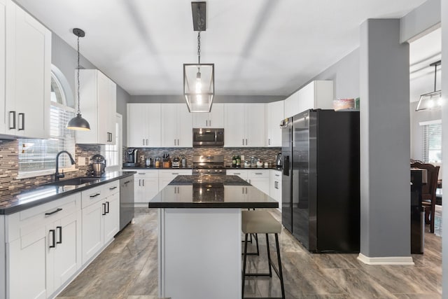 4914 Fern Cove Dr, Baytown, TX 77521 - kitchen with stainless steel appliances, a sink, dark countertops, and backsplash
