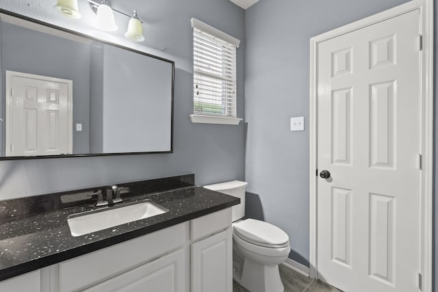 4914 Fern Cove Dr, Baytown, TX 77521 - half bathroom featuring toilet, vanity, and tile patterned flooring