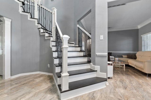 4914 Fern Cove Dr, Baytown, TX 77521 - stairs with crown molding, a towering ceiling, baseboards, and marble finish flooring