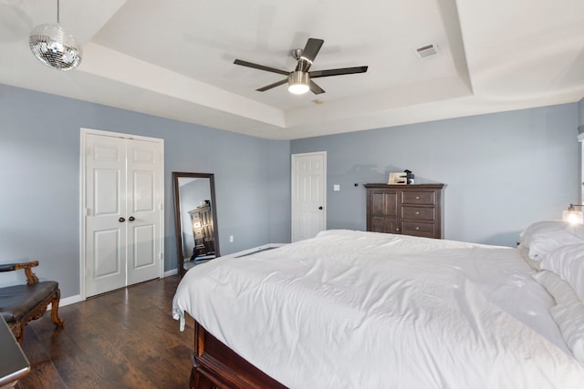 4914 Fern Cove Dr, Baytown, TX 77521 - bedroom featuring a raised ceiling, wood finished floors, baseboards, and ceiling fan