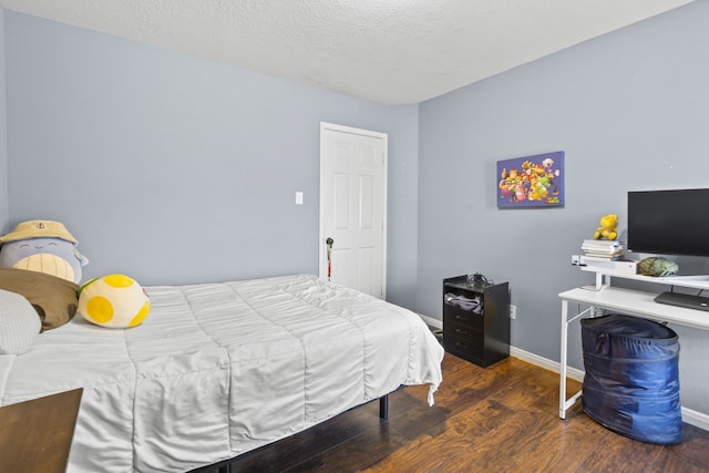 4914 Fern Cove Dr, Baytown, TX 77521 - bedroom with wood finished floors, baseboards, and a textured ceiling
