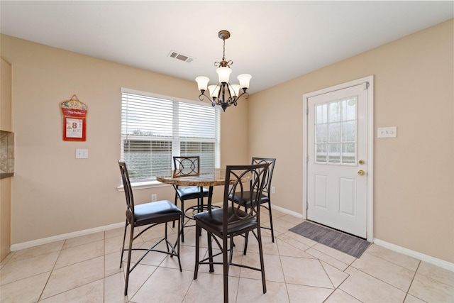 8123 Solara Bnd, Houston, TX 77083 - dining room featuring healthy amount of natural light, a chandelier, baseboards, and light tile patterned floors
