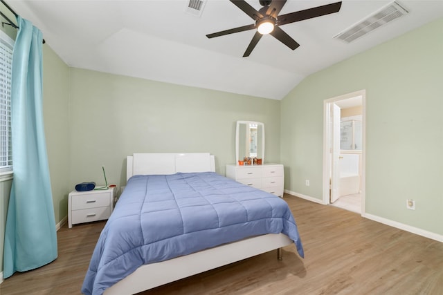 8123 Solara Bnd, Houston, TX 77083 - bedroom featuring light wood-style floors, lofted ceiling, baseboards, connected bathroom, and a ceiling fan