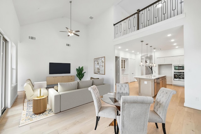 510 Rita Blanca Dr, Webster, TX 77598 - dining area with a ceiling fan, high vaulted ceiling, light wood-style floors, and recessed lighting