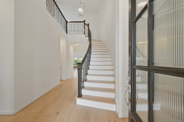 510 Rita Blanca Dr, Webster, TX 77598 - stairs featuring wood finished floors, baseboards, and a high ceiling