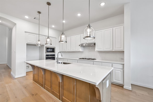 510 Rita Blanca Dr, Webster, TX 77598 - kitchen with oven, a sink, built in microwave, gas cooktop, and baseboards