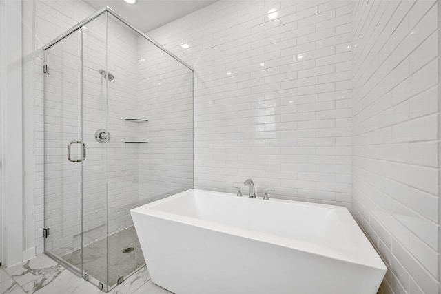 510 Rita Blanca Dr, Webster, TX 77598 - bathroom with marble finish flooring, a shower stall, a freestanding bath, tile walls, and recessed lighting