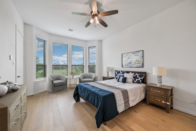 510 Rita Blanca Dr, Webster, TX 77598 - bedroom with light wood-style flooring, baseboards, and ceiling fan