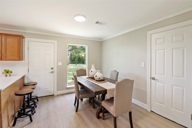 240 Sleepy Hollow Dr, Lake Jackson, TX 77566 - dining room with ornamental molding, light wood finished floors, and baseboards