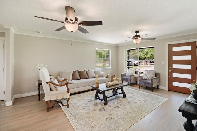 240 Sleepy Hollow Dr, Lake Jackson, TX 77566 - living room featuring ceiling fan, light wood-style flooring, ornamental molding, baseboards, and a textured ceiling