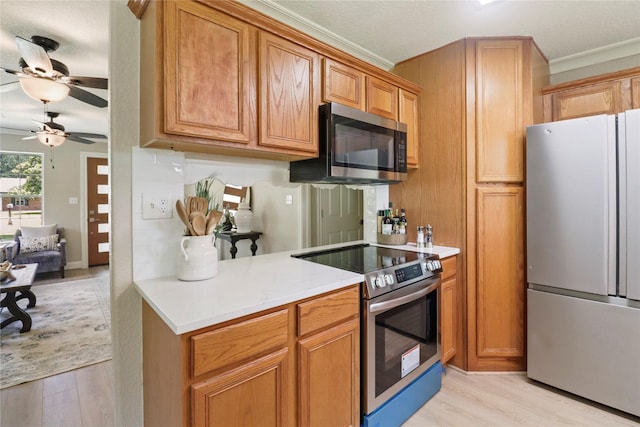 240 Sleepy Hollow Dr, Lake Jackson, TX 77566 - kitchen featuring stainless steel appliances, light wood finished floors, ceiling fan, light countertops, and crown molding