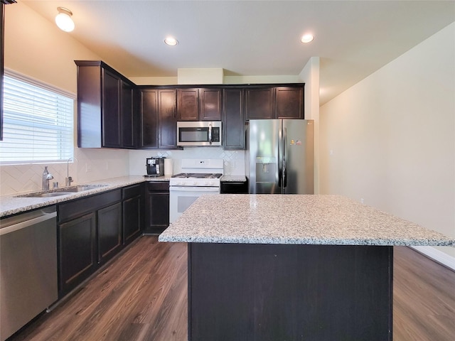 3430 Hughes Meadow Way, Richmond, TX 77406 - kitchen with appliances with stainless steel finishes, a sink, dark wood finished floors, backsplash, and recessed lighting