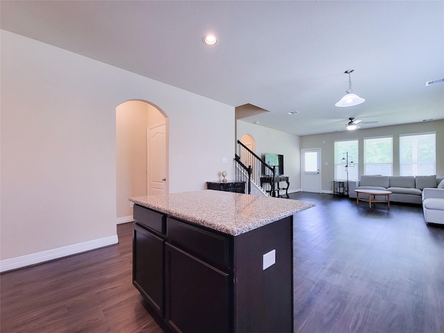 3430 Hughes Meadow Way, Richmond, TX 77406 - kitchen with ceiling fan, arched walkways, a kitchen island, and baseboards
