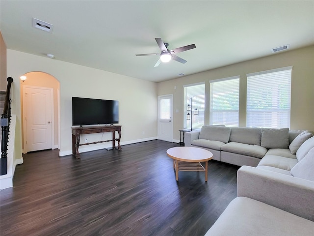3430 Hughes Meadow Way, Richmond, TX 77406 - living area with arched walkways, dark wood-style flooring, a ceiling fan, and baseboards