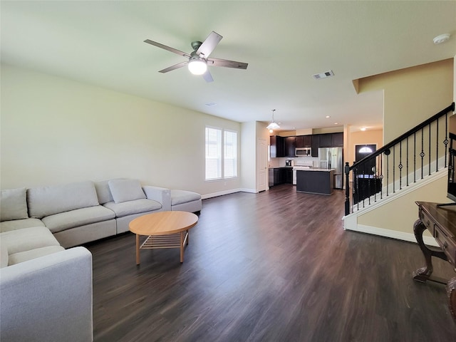 3430 Hughes Meadow Way, Richmond, TX 77406 - living room with dark wood-style floors, a ceiling fan, baseboards, and stairs
