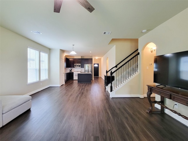 3430 Hughes Meadow Way, Richmond, TX 77406 - living area with baseboards, dark wood finished floors, stairs, and arched walkways