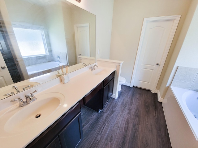 3430 Hughes Meadow Way, Richmond, TX 77406 - full bath featuring toilet, a bath, double vanity, and wood finished floors