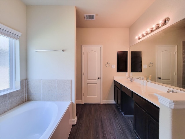 3430 Hughes Meadow Way, Richmond, TX 77406 - bathroom with wood finished floors, plenty of natural light, a bath, and double vanity