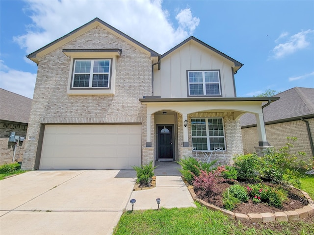 3430 Hughes Meadow Way, Richmond, TX 77406 - view of front facade with board and batten siding, a garage, a porch, and brick siding