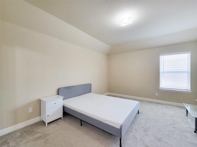 3430 Hughes Meadow Way, Richmond, TX 77406 - bedroom featuring light colored carpet, baseboards, vaulted ceiling, and a textured ceiling