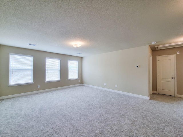 3430 Hughes Meadow Way, Richmond, TX 77406 - spare room with light colored carpet, a textured ceiling, baseboards, and attic access