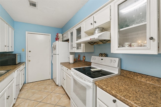 kitchen featuring white appliances, under cabinet range hood, white cabinets, glass insert cabinets, and light tile patterned floors