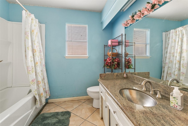 bathroom featuring toilet, tile patterned flooring, vanity, baseboards, and shower / bathtub combination with curtain