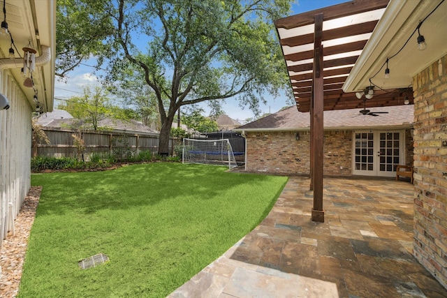 12310 Woodthorpe Ln, Houston, TX 77024 - view of yard featuring french doors, ceiling fan, and a patio area