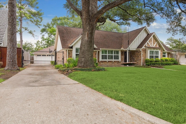 12310 Woodthorpe Ln, Houston, TX 77024 - tudor-style house featuring a gate, board and batten siding, brick siding, a front lawn, and driveway