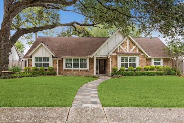 12310 Woodthorpe Ln, Houston, TX 77024 - tudor home with board and batten siding, brick siding, and roof with shingles