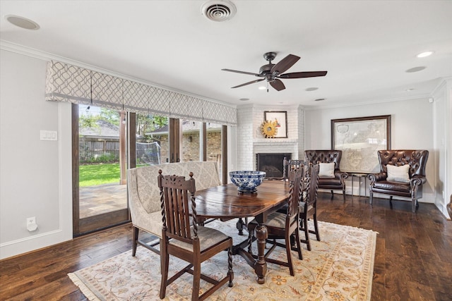 12310 Woodthorpe Ln, Houston, TX 77024 - dining space with plenty of natural light, baseboards, ornamental molding, a brick fireplace, and hardwood / wood-style flooring