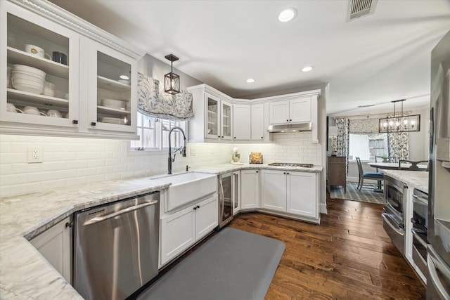 12310 Woodthorpe Ln, Houston, TX 77024 - kitchen with stainless steel appliances, a sink, white cabinetry, light stone counters, and beverage cooler