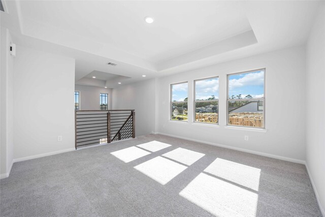 11765 Whirlaway Dr, Willis, TX 77318 - spare room featuring a raised ceiling, carpet flooring, recessed lighting, and baseboards