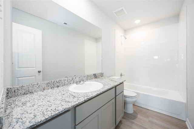 11765 Whirlaway Dr, Willis, TX 77318 - bathroom featuring wood finished floors, toilet, vanity, and shower / bath combination