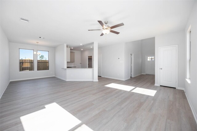 11765 Whirlaway Dr, Willis, TX 77318 - unfurnished living room featuring plenty of natural light, ceiling fan, baseboards, light wood-type flooring, and recessed lighting