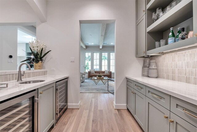 3314 La Salle St, Houston, TX 77027 - bar featuring beverage cooler, light wood-style floors, and tasteful backsplash