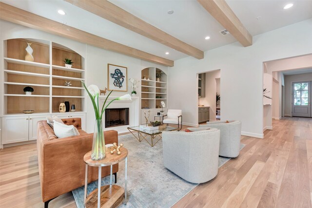 3314 La Salle St, Houston, TX 77027 - living area with beamed ceiling, light wood-type flooring, built in shelves, a fireplace, and recessed lighting