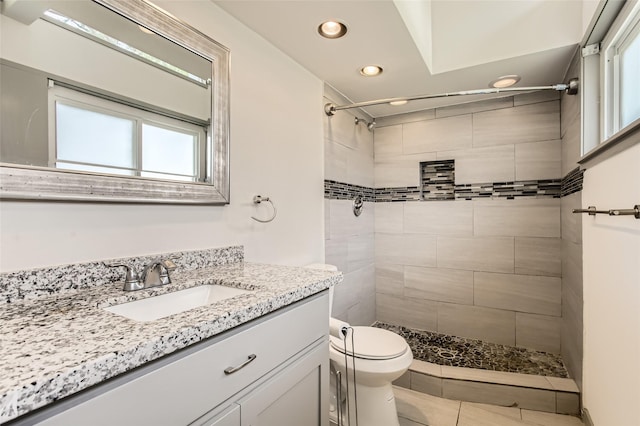 6509 Birdwood Rd, Houston, TX 77074 - full bath with recessed lighting, toilet, tiled shower, vanity, and tile patterned flooring